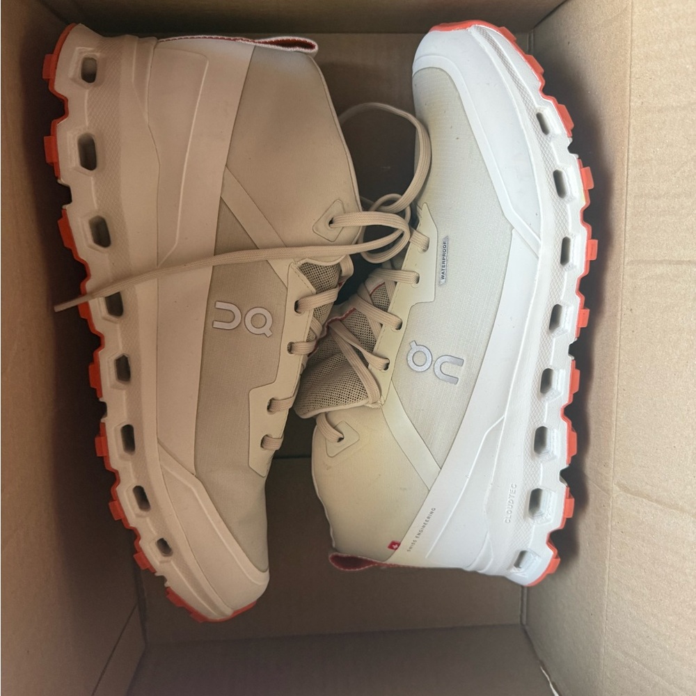 On Running White and Orange Sneakers